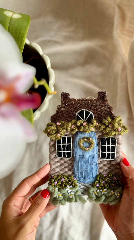 Grey cottage with daisies