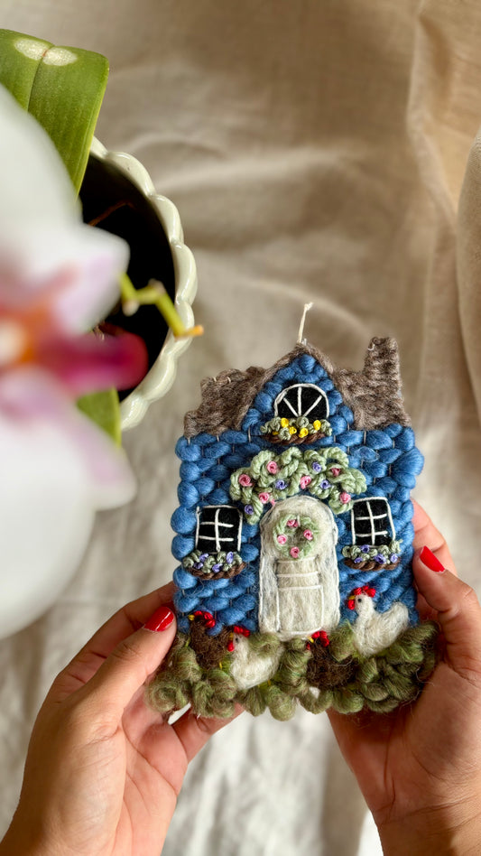 Blue cottage with chickens